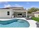 A refreshing pool with a sun shelf and outdoor kitchen area, perfect for relaxing and entertaining in style at 4013 Red Rock Ln, Sarasota, FL 34231