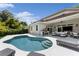 A beautifully landscaped pool with a lounge area and outdoor kitchen, ideal for entertaining guests at 4013 Red Rock Ln, Sarasota, FL 34231