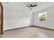 Comfortable bedroom featuring wood-look tile flooring, natural lighting, and a ceiling fan at 405 Sunset N Rd, Rotonda West, FL 33947