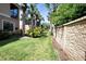 Well-maintained backyard with a stone wall and tropical landscaping at 4069 Overture Cir # 341, Bradenton, FL 34209