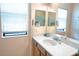 Bright bathroom featuring a large vanity with ample counter space, modern fixtures, and large mirror at 4069 Overture Cir # 341, Bradenton, FL 34209