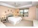 Comfortable bedroom features a ceiling fan, large window, and a serene ambiance with neutral colors at 4069 Overture Cir # 341, Bradenton, FL 34209
