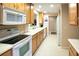 Well-lit kitchen featuring white countertops, modern appliances, and light wooden cabinets at 4069 Overture Cir # 341, Bradenton, FL 34209