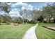 Scenic walking path with a bench and lush landscaping at 4069 Overture Cir # 341, Bradenton, FL 34209