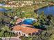 Aerial view of the community clubhouse and pool with lush landscaping at 4136 Cascade Falls Dr, Sarasota, FL 34243