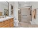 Bathroom with glass-enclosed shower, handrails, and a neutral color scheme at 4136 Cascade Falls Dr, Sarasota, FL 34243