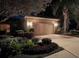 Nighttime view of home with manicured landscaping, illuminated by outdoor lighting, creating an inviting and secure ambiance at 4136 Cascade Falls Dr, Sarasota, FL 34243