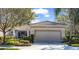 Charming home features a tile roof, manicured landscaping, and a two-car garage, enhancing its curb appeal at 4136 Cascade Falls Dr, Sarasota, FL 34243