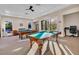 Bright game room featuring billiard tables, comfortable seating and natural lighting at 4136 Cascade Falls Dr, Sarasota, FL 34243