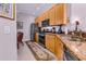 A kitchen featuring wood cabinetry, stainless steel appliances and a breakfast nook in the background at 4136 Cascade Falls Dr, Sarasota, FL 34243