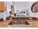 Close up of the stainless steel sink and granite counter tops with decor at 4136 Cascade Falls Dr, Sarasota, FL 34243