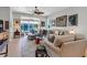 Bright living room with neutral furniture, ceiling fan and view to screened patio at 4136 Cascade Falls Dr, Sarasota, FL 34243