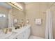 This upscale bathroom boasts double sinks, luxurious gold fixtures, and ample lighting at 4146 Westbourne Cir, Sarasota, FL 34238
