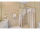 Elegant bathroom with gold fixtures, a walk-in shower, and a marble countertop vanity at 4146 Westbourne Cir, Sarasota, FL 34238