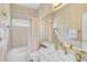 Elegant bathroom featuring gold fixtures, a bathtub, and a large mirror at 4146 Westbourne Cir, Sarasota, FL 34238