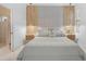 Stylish bedroom with wood accent walls, pendant lighting, and a glimpse into the ensuite at 4146 Westbourne Cir, Sarasota, FL 34238