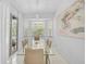 Bright dining room featuring a glass table, tan chairs, lots of natural light, and modern art at 4146 Westbourne Cir, Sarasota, FL 34238