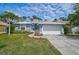 Charming home featuring a manicured lawn, paved driveway, two-car garage, and inviting curb appeal at 4146 Westbourne Cir, Sarasota, FL 34238