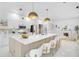 Bright, white kitchen with large island, modern lighting, and stylish seating for a modern aesthetic at 4146 Westbourne Cir, Sarasota, FL 34238