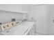 Bright laundry room with modern appliances, white cabinets, and efficient design at 4146 Westbourne Cir, Sarasota, FL 34238