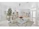 Open-concept living room with stylish seating, modern kitchen, marble floors, and elegant decor at 4146 Westbourne Cir, Sarasota, FL 34238