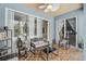 Enclosed patio featuring comfortable seating, wood floors, ceiling fan, and view of the pool area at 4146 Westbourne Cir, Sarasota, FL 34238