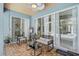 Enclosed patio with stylish furniture, fan, wood flooring, and sliding glass doors overlooking the pool at 4146 Westbourne Cir, Sarasota, FL 34238