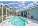 Screened pool featuring blue waters, ample seating, outdoor grill, and lush surrounding greenery at 4146 Westbourne Cir, Sarasota, FL 34238
