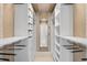 Custom walk-in closet with built-in shelving, drawers, and plenty of storage for clothing at 4146 Westbourne Cir, Sarasota, FL 34238