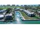 Stunning aerial view of the community with boat docks, waterfront condos, and lush landscaping at 450 Gulf Of Mexico Dr # B207, Longboat Key, FL 34228
