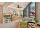 Sitting area with a view into a bedroom with a flat screen TV, lamps and view of the balcony at 450 Gulf Of Mexico Dr # B207, Longboat Key, FL 34228