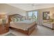 Light-filled bedroom boasts a large window with stunning views, king bed, and neutral decor at 450 Gulf Of Mexico Dr # B207, Longboat Key, FL 34228