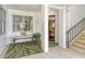 Welcoming entrance featuring a cozy bench, stylish rug, and staircase leading to the upper levels at 450 Gulf Of Mexico Dr # B207, Longboat Key, FL 34228