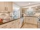 Bright kitchen boasts granite counters, stainless appliances, tile backsplash and flooring at 450 Gulf Of Mexico Dr # B207, Longboat Key, FL 34228