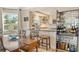 Charming kitchen featuring granite counters, bright white cabinets, bar and hardwood floors at 450 Gulf Of Mexico Dr # B207, Longboat Key, FL 34228