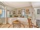 Cozy living area with a daybed, round coffee table, and nautical-themed art at 450 Gulf Of Mexico Dr # B207, Longboat Key, FL 34228