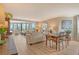 Bright living room features wood floors, neutral tones, a balcony and comfortable seating at 450 Gulf Of Mexico Dr # B207, Longboat Key, FL 34228