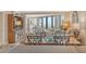 Elegant living room boasting large windows offering beautiful views and stylish furnishings at 450 Gulf Of Mexico Dr # B207, Longboat Key, FL 34228