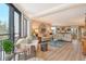 Bright open-plan living room featuring wood floors, plush seating, balcony and an adjacent kitchen at 450 Gulf Of Mexico Dr # B207, Longboat Key, FL 34228