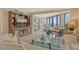 Inviting living room with a large glass coffee table, comfortable seating, and stylish decor at 450 Gulf Of Mexico Dr # B207, Longboat Key, FL 34228