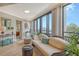 Cozy living area with water views, comfortable furnishings, and sliding glass door to the balcony at 450 Gulf Of Mexico Dr # B207, Longboat Key, FL 34228