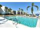 Community pool with waterfront condo building in the background and dock access at 450 Gulf Of Mexico Dr # B207, Longboat Key, FL 34228