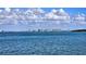 View of the city skyline across the water under a bright blue sky with puffy clouds at 450 Gulf Of Mexico Dr # B207, Longboat Key, FL 34228