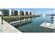 Waterfront view from dock, with boats and condos in the background at 450 Gulf Of Mexico Dr # B207, Longboat Key, FL 34228