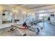 Workout room with fitness equipment, mirrors, and natural light at 450 Gulf Of Mexico Dr # B207, Longboat Key, FL 34228