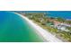 Stunning aerial view showcases the community's prime beachfront location, pristine beaches, and turquoise waters at 4760 Gulf Of Mexico Dr. Villa 7, Longboat Key, FL 34228