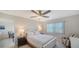 Bright bedroom with a ceiling fan, large window, and neutral decor at 4760 Gulf Of Mexico Dr. Villa 7, Longboat Key, FL 34228