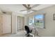 This bedroom has a ceiling fan, a closet, and a large window with a view at 4760 Gulf Of Mexico Dr. Villa 7, Longboat Key, FL 34228