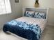 Cozy bedroom featuring vibrant, seashell-patterned bedding and a pineapple decoration at 4760 Gulf Of Mexico Dr. Villa 7, Longboat Key, FL 34228