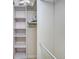 Spacious closet with built-in shelving and ample storage space, and pull down bar at 4760 Gulf Of Mexico Dr. Villa 7, Longboat Key, FL 34228
